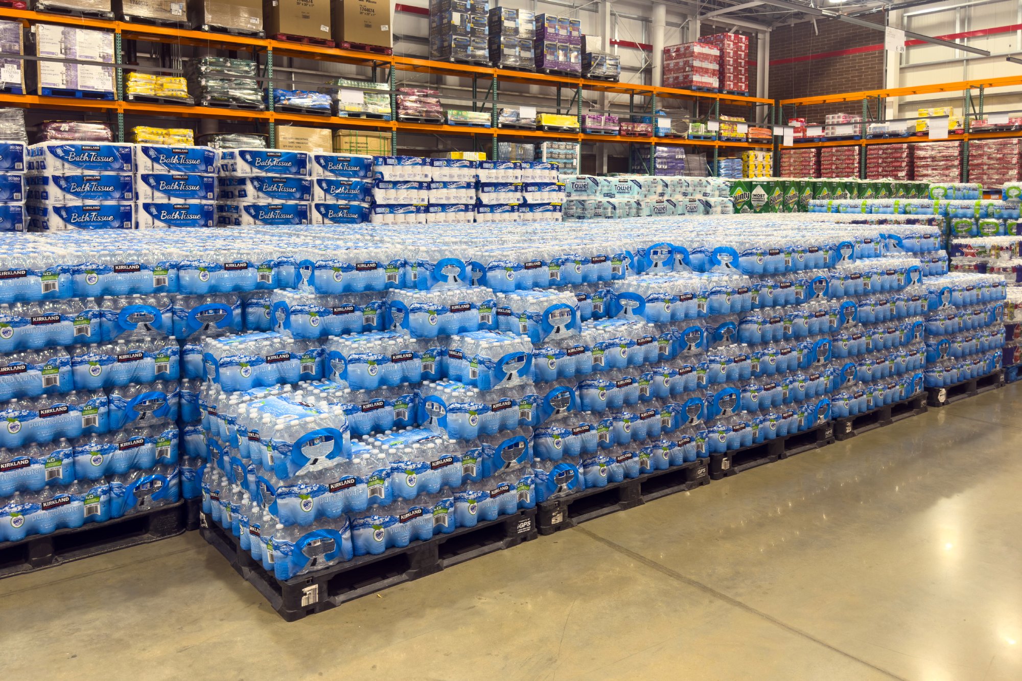 Bottled water pallets stacked in warehouse aisle